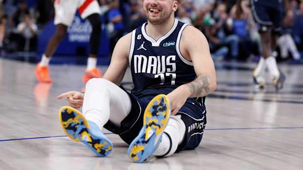 Luka Doncic sits on the court.